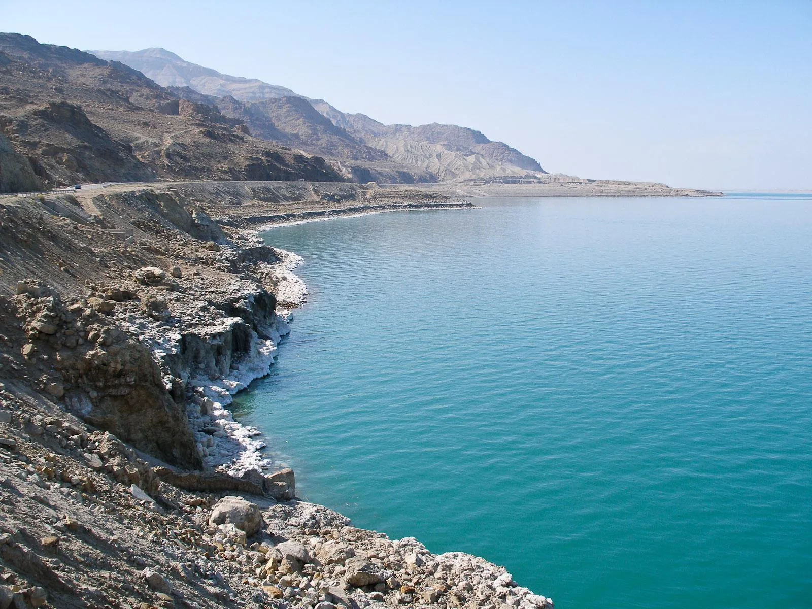 The Dead Sea Highway running along the shoreline below the escarpment on the Jordanian side