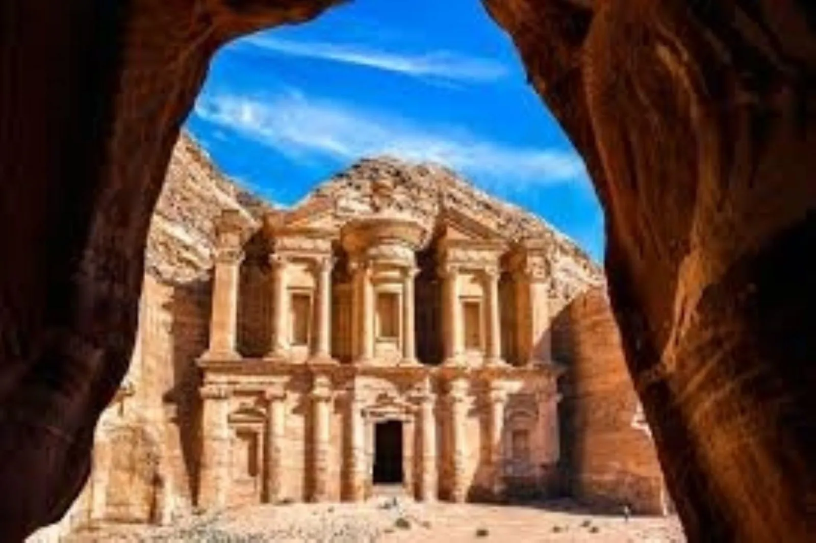 Petra's Monastery framed by the sandstone cleft that visitors climb to reach it